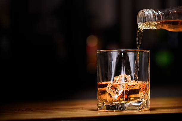 Still life. pour or whiskey in to glass.